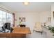 Bright office featuring a large desk, an accent chair, and shelving at 2829 S Fig St, Lakewood, CO 80228