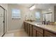 Bathroom featuring a double sink vanity with granite countertops and a glass-enclosed shower at 16461 E 119Th Way # B, Commerce City, CO 80022