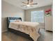 Bedroom featuring a ceiling fan, plush bedding, and large window with a neighborhood view at 16461 E 119Th Way # B, Commerce City, CO 80022
