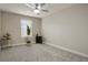 Cozy bedroom featuring neutral walls, a ceiling fan, and a window with natural light at 16461 E 119Th Way # B, Commerce City, CO 80022