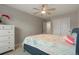 Bright bedroom features a ceiling fan, plush bedding, and a large closet with sliding doors at 16461 E 119Th Way # B, Commerce City, CO 80022