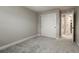 Clean bedroom featuring neutral walls, soft carpeting, and a closet with sliding doors at 16461 E 119Th Way # B, Commerce City, CO 80022