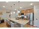 Modern kitchen featuring stainless steel appliances and a large island with bar seating at 16461 E 119Th Way # B, Commerce City, CO 80022