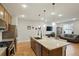 Gourmet kitchen with a large island, pendant lighting, and stainless steel appliances at 16461 E 119Th Way # B, Commerce City, CO 80022