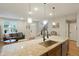 Open-concept kitchen with hardwood floors, a large island, and seamless flow to the living area at 16461 E 119Th Way # B, Commerce City, CO 80022