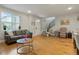 Bright living room with hardwood floors, a leather sofa, and modern staircase leading upstairs at 16461 E 119Th Way # B, Commerce City, CO 80022