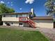 Back exterior of the home featuring a wooden deck and stairs to the grassy yard at 1265 S Biscay St, Aurora, CO 80017