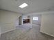 Large basement with exposed brick fireplace, neutral paint, and access to other rooms at 1265 S Biscay St, Aurora, CO 80017