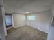 Basement features a large window, neutral walls, carpet flooring, and access to additional rooms at 1265 S Biscay St, Aurora, CO 80017