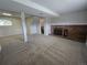 Finished basement area with brick fireplace, carpet, and plenty of open space for recreation at 1265 S Biscay St, Aurora, CO 80017