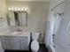Well-lit bathroom with marble-style vanity, a shower-tub combination, and modern fixtures at 1265 S Biscay St, Aurora, CO 80017