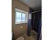 This bathroom offers a glass shower, a large window, and tiled walls at 1265 S Biscay St, Aurora, CO 80017