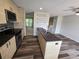 Modern kitchen features stainless steel appliances, sleek cabinets, and an island with sink at 1265 S Biscay St, Aurora, CO 80017