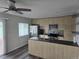Modern kitchen features stainless steel appliances, sleek cabinets, and an island with sink at 1265 S Biscay St, Aurora, CO 80017