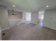 Open-concept living space with neutral color palette and access to the kitchen with wood floors at 1265 S Biscay St, Aurora, CO 80017