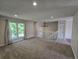 Spacious living room with large window, recessed lighting, neutral tones, and access to the staircase at 1265 S Biscay St, Aurora, CO 80017