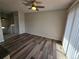 Bright living room with wood flooring, large windows, and access to stairs at 1265 S Biscay St, Aurora, CO 80017