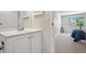 Clean bathroom with white vanity and a glimpse into the bright bedroom, creating a seamless flow at 943 S Zeno Way # 102, Aurora, CO 80017