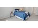 Cozy bedroom featuring a comfortable bed, neutral carpet, and a view to the ensuite bathroom at 943 S Zeno Way # 102, Aurora, CO 80017