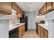 Well-lit kitchen features wooden cabinets, tile backsplash, and dark appliances at 943 S Zeno Way # 102, Aurora, CO 80017