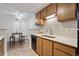 Kitchen with stainless steel sink, wood cabinets, stylish tile backsplash and dining area at 943 S Zeno Way # 102, Aurora, CO 80017