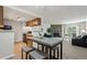 Open floorplan living room showing dining area, fireplace, and connection to kitchen at 943 S Zeno Way # 102, Aurora, CO 80017