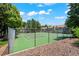 Well-kept tennis court offering a great amenity within the community, surrounded by mature trees at 943 S Zeno Way # 102, Aurora, CO 80017