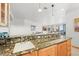 Stylish bar area with granite countertops, a sink, and cabinetry, creating a perfect space for entertaining and serving guests at 156 S Lookout Mountain Rd, Golden, CO 80401