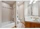 Bright bathroom featuring tiled walls, tub with shower, and a vanity with tiled countertop, providing a clean and functional space at 156 S Lookout Mountain Rd, Golden, CO 80401