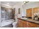 Beautiful bathroom featuring stone tiled shower and dark stone countertops with wooden vanity, offers a spa-like retreat at 156 S Lookout Mountain Rd, Golden, CO 80401
