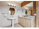 Bathroom featuring a pedestal sink, natural wood vanity, and decorative framed mirrors at 156 S Lookout Mountain Rd, Golden, CO 80401