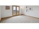 Bedroom with light-colored carpet and doors to a balcony offering scenic views at 156 S Lookout Mountain Rd, Golden, CO 80401