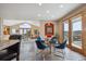 Open-concept dining area with a glass table, blue chairs, and sliding glass doors to the outside at 156 S Lookout Mountain Rd, Golden, CO 80401