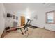 Exercise room features a treadmill, weight machine, TV, and wood door at 156 S Lookout Mountain Rd, Golden, CO 80401