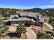 Stunning home featuring a stone driveway, mature trees, and a roof with multiple dormers and a stone chimney at 156 S Lookout Mountain Rd, Golden, CO 80401