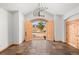 Inviting foyer with tile floors, wood trim, arched doorway, and modern chandelier at 156 S Lookout Mountain Rd, Golden, CO 80401