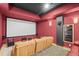 Home theater featuring a large projection screen, comfortable seating, and dark walls for an immersive experience at 156 S Lookout Mountain Rd, Golden, CO 80401