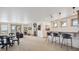 Open-concept living room featuring a fireplace, bar seating, natural light, and a flat-screen TV at 156 S Lookout Mountain Rd, Golden, CO 80401
