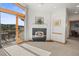 Bright living room with fireplace and access to a private deck with scenic views at 156 S Lookout Mountain Rd, Golden, CO 80401