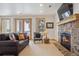 Inviting living room featuring a stone fireplace, plush seating, and natural light, perfect for relaxing and entertaining guests at 156 S Lookout Mountain Rd, Golden, CO 80401
