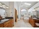 Luxurious main bathroom with dual vanities, a soaking tub, and a skylight at 156 S Lookout Mountain Rd, Golden, CO 80401
