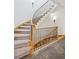 Elegant staircase with carpeted steps and wrought iron spindles and wooden handrail at 156 S Lookout Mountain Rd, Golden, CO 80401