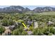 Aerial view of a property showcasing its proximity to mountains, mature trees, and neighborhood at 1560 Findlay Way, Boulder, CO 80305
