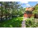 Expansive backyard showcasing a stone pathway and lush greenery, perfect for outdoor relaxation and entertaining at 1560 Findlay Way, Boulder, CO 80305