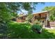 A lush green backyard with a raised garden bed and multilevel wooden decks connected with stairs at 1560 Findlay Way, Boulder, CO 80305