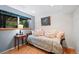 Comfortable bedroom with daybed, soft pillows, wood floors, and a window overlooking the serene outdoors at 1560 Findlay Way, Boulder, CO 80305