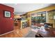 Sunny kitchen with bar seating, sliding door access to the deck, and dining area with wood floors at 1560 Findlay Way, Boulder, CO 80305