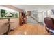 Bright living area with hardwood floors, large window, staircase and built-in shelves offering ample natural light at 1560 Findlay Way, Boulder, CO 80305