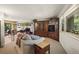 Open-concept living room with dining area, large windows, and access to the outdoor deck at 1560 Findlay Way, Boulder, CO 80305