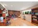 Inviting living room featuring a cozy brick fireplace, ample natural light, and wood flooring at 1560 Findlay Way, Boulder, CO 80305
